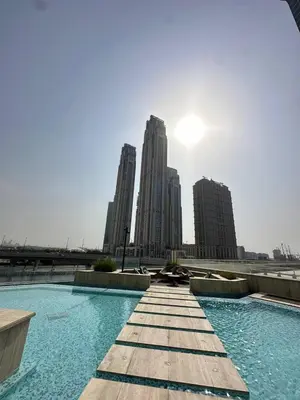a swimming pool in a city with tall buildings at Infinity Pool - 6 minutes to Dubai Mall - Luxury in Dubai