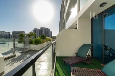 a balcony with a chair on a building at Stylish Living with a Cozy Touch in Dubai