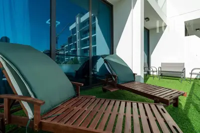 a tent and a wooden bench on the grass at Stylish Living with a Cozy Touch in Dubai