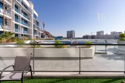 a chair on the balcony of a building at Stylish Living with a Cozy Touch in Dubai