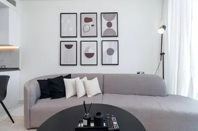 a living room with a couch and a table at Stylish Living with a Cozy Touch in Dubai