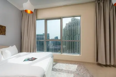 a bedroom with a bed and a large window at Great Location - Stunning Views - Scenic in Dubai