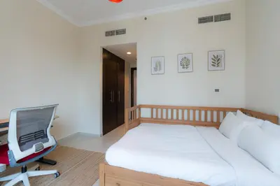a bedroom with a bed and a desk with a tv at Great Location - Stunning Views - Scenic in Dubai