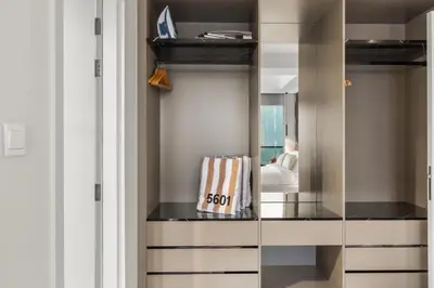a dressing room with a mirror and a closet at Luxe High-Rise with Burj Khalifa and Sunset view in Dubai