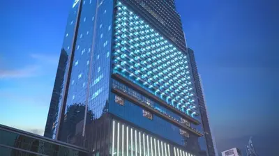 a tall blue building with lots of windows at Luxe High-Rise with Burj Khalifa and Sunset view in Dubai
