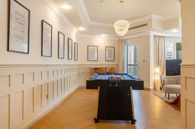 a game room with a pool table in it at SkyHigh 4BR Penthouse Marina Views & Game Lounge Pool Table PS5 in Dubai