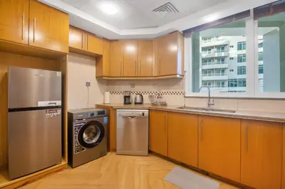 a kitchen with a dishwasher and a washer in it at SkyHigh 4BR Penthouse Marina Views & Game Lounge Pool Table PS5 in Dubai