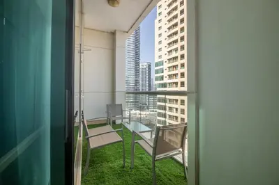 a balcony with a view of a city at SkyHigh 4BR Penthouse Marina Views & Game Lounge Pool Table PS5 in Dubai