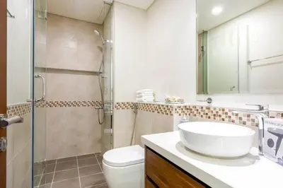 a bathroom with a sink and a shower and a toilet at Luxury Apartment in the Heart of the City in Dubai