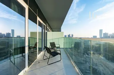 a balcony with chairs and a view of the city at Luxury Apartment in the Heart of the City in Dubai
