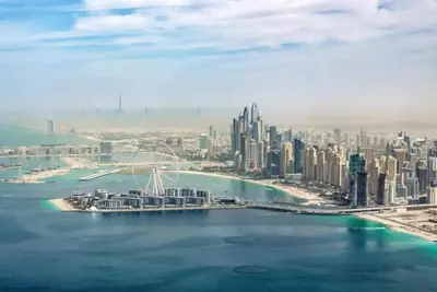 an aerial view of a city with a bridge in the water at Hospitality Expert Rimal 5BR Marina Beach Pool in Dubai