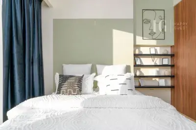 a bedroom with a bed with white sheets and pillows at Modern Comfort in Business Bay in Dubai