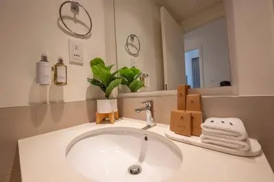a bathroom with a white sink and a mirror at Designer 1 Bedroom Apartments in Dubai Hills Estate in Dubai