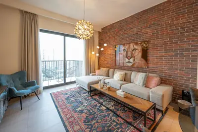 a living room with a brick wall at Designer 1 Bedroom Apartments in Dubai Hills Estate in Dubai