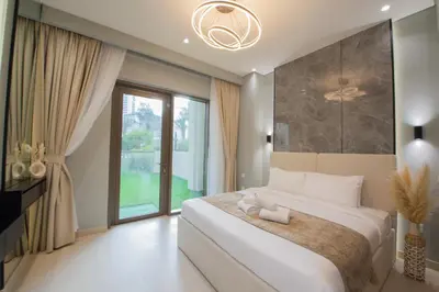 a bedroom with a large bed and a large window at Rosewater at Creek Beach Building 2 Luxury Creekside Living with Beach & Pool Access in Dubai