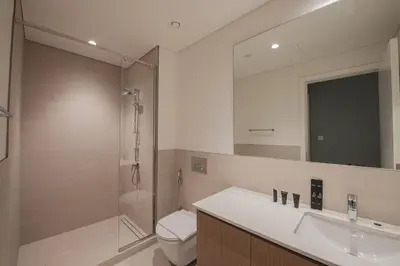 a bathroom with a sink and a shower and a toilet at Rosewater at Creek Beach Building 2 Luxury Creekside Living with Beach & Pool Access in Dubai