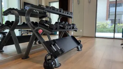 a gym with several tread machines in a room at Rosewater at Creek Beach Building 2 Luxury Creekside Living with Beach & Pool Access in Dubai
