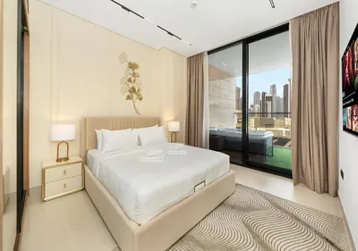 a bedroom with a bed and a large window at Luxury 1 BR Apartment with Private Jacuzzi in Dubai