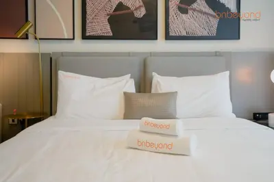 a white bed with two towels on top of it at Magnificent living at Downtown in Dubai