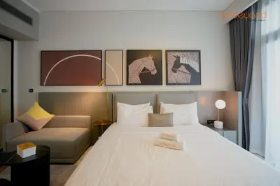 a bedroom with a large white bed and a couch at Magnificent living at Downtown in Dubai