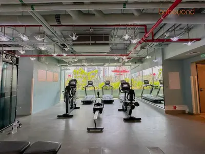 a gym with a row of exercise bikes in a room at Magnificent living at Downtown in Dubai