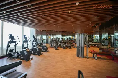 a gym with treadmills and ellipticals in a building at Bnbeyond Contemporary Living in Business Bay in Dubai