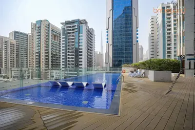 a swimming pool in a city with tall buildings at Bnbeyond Contemporary Living in Business Bay in Dubai