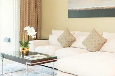 a living room with two white couches and a coffee table at PVH - Emaar Fashion Avenue - 1BR Dubai Mall Access in Dubai