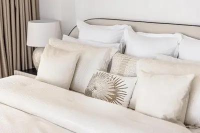a pile of white pillows on a bed at Amazing, Spacious 2-bed with fantastic sea view! in Dubai