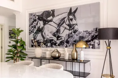 a living room with a horse picture on the wall at Amazing, Spacious 2-bed with fantastic sea view! in Dubai