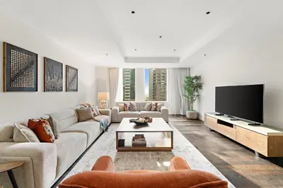 a living room with a couch and a flat screen tv at FIRST CLASS 2BR Spacious DIFC Living in Dubai
