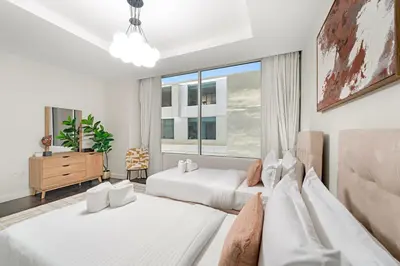 a bedroom with two beds and a window at FIRST CLASS 2BR Spacious DIFC Living in Dubai