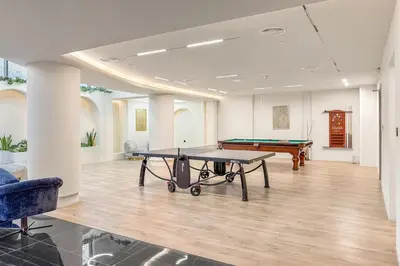 a living room with a ping pong table in it at FIRST CLASS Studio Minimalist Chic Retreat in Dubai