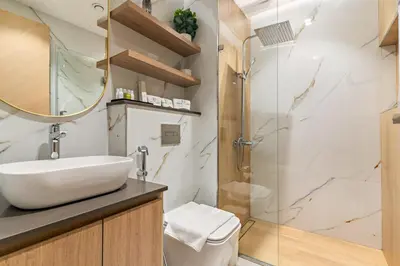 a bathroom with a sink and a shower at FIRST CLASS Studio Minimalist Chic Retreat in Dubai