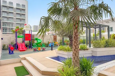 a playground with a palm tree in a building at FIRST CLASS Studio Minimalist Chic Retreat in Dubai