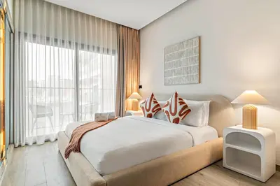 a bedroom with a large bed and a large window at FIRST CLASS Studio Minimalist Chic Retreat in Dubai