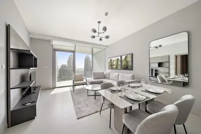 a white living room with a table and chairs at FIRST CLASS 1BR Majestic Marina Views in Dubai