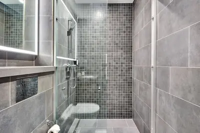 a bathroom with a glass shower with a toilet at STAY BY LATINEM Luxury 1BR Plus Study Holiday Home CB 3714 Near Burj Khalifa in Dubai
