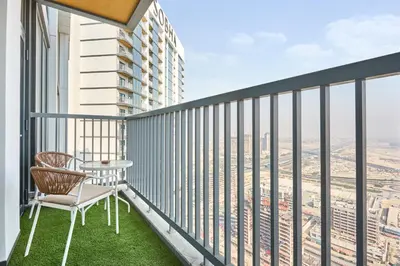 a balcony with a table and chair on a building at STAY BY LATINEM Luxury 1BR Plus Study Holiday Home CB 3714 Near Burj Khalifa in Dubai