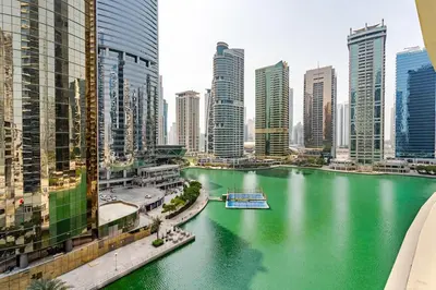 a river in the middle of a city with tall buildings at Stunning lake view 1bedroom apartment in Jlt in Dubai