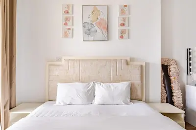 a bedroom with a white bed with two pictures on the wall at Stunning lake view 1bedroom apartment in Jlt in Dubai