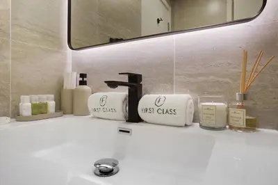 a bathroom sink with two towels and a faucet at FIRST CLASS 2BR Burj Views & Classy Comfort in Dubai