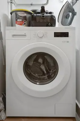 a washing machine with a toaster on top of it at FIRST CLASS 2BR Burj Views & Classy Comfort in Dubai