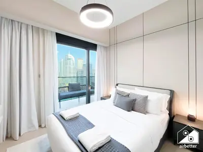 a bedroom with a large bed and a large window at Skyline Elegance, Fountain View 3BR in Downtown in Dubai