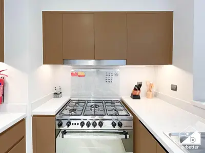 a kitchen with a stove top oven in a kitchen at Skyline Elegance, Fountain View 3BR in Downtown in Dubai