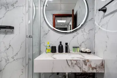a bathroom with a sink and a mirror at Waves - Cozy & Fully Furnished Studio in Dubai Sports City in Dubai