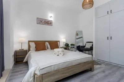 a bedroom with a large bed with two towels on it at Waves - Cozy & Fully Furnished Studio in Dubai Sports City in Dubai