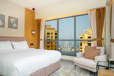 a hotel room with a bed and a large window at Luxury 2BR - Stunning Marina View and JBR Beach in Dubai