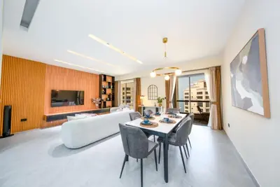 a living room with a couch and a table and chairs at Luxury 2BR - Stunning Marina View and JBR Beach in Dubai