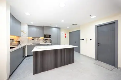 a large kitchen with a large island in the middle at Luxury 2BR - Stunning Marina View and JBR Beach in Dubai